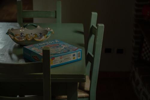 a book sitting on a table next to a bowl at Consi's House - ItalyWeGo in Torgiano