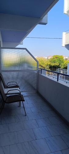 a balcony with a bench on a roof at Pyrgos Hotel Apartments in Kremasti