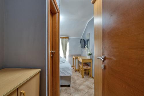 a hallway with a door to a kitchen with a table at Hotel Rendez Vous in Kotor