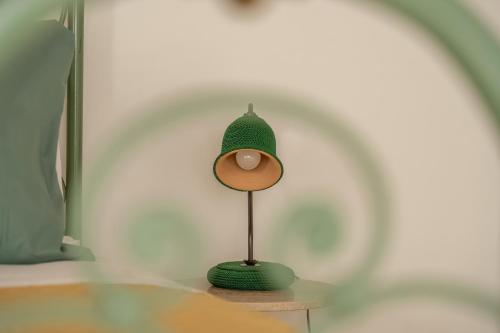 a green lamp sitting on a glass table at Consi's House - ItalyWeGo in Torgiano