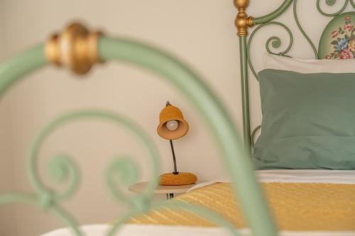 a lamp sitting on a table next to a bed at Consi's House - ItalyWeGo in Torgiano