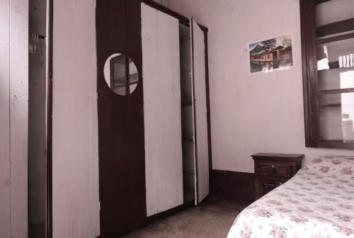 a bedroom with a door with a mirror and a bed at Casa Seibel in Quetzaltenango