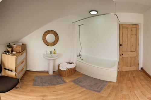 a bathroom with a bath tub and a sink at The Palace Villas - Location, Luxury and Space in Eastbourne