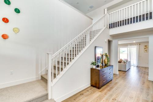 a staircase in a home with white walls and wooden floors at Pool Paradise Spacious Tracy Home with Yard! in Tracy