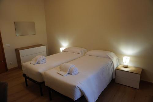 two beds in a hotel room with towels on them at Hello Francesca Guesthouse in Florence
