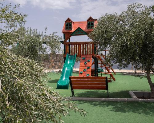 a playground with a slide and a slidesktopktopktopktopktopktopktopktop at Sama Hotel Jabal Al Akhdar in Al ‘Aqar