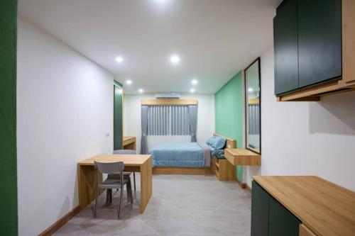 a small room with a table and a bed at Terpenica in Pattaya
