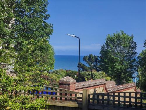 a wooden fence with a view of the ocean at Seaside studio for business or holiday travellers in Eastbourne