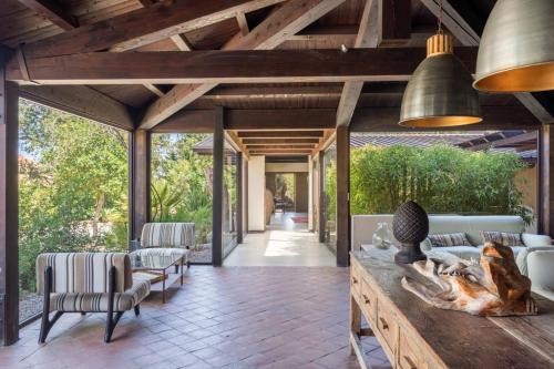an open living room with vaulted ceilings and a wooden ceiling at Vallegrande Nature Resort by Geocharme in Cefalù