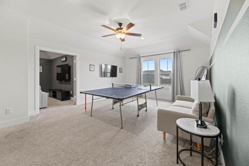 a living room with a table and a couch at Lake Cove Retreat in Little Elm