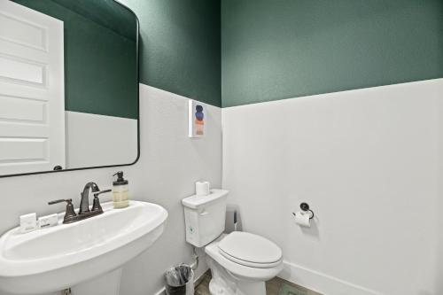 a bathroom with a white toilet and a sink at Lake Cove Retreat in Little Elm