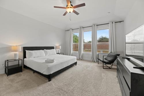 a bedroom with a bed and a ceiling fan at Lake Cove Retreat in Little Elm