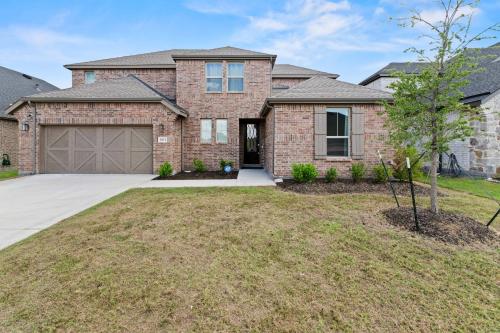 a large brick house with a garage at Lake Cove Retreat in Little Elm
