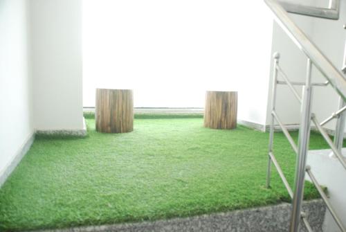 a room with green carpet on the floor at Runway Residency at Pitampura in New Delhi