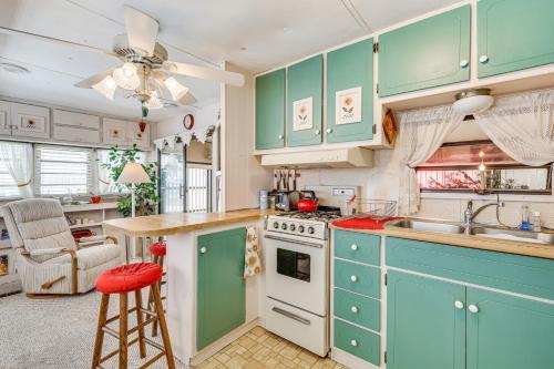 a kitchen with green cabinets and a sink and a counter at Swim, Fish and Play Pet-Friendly Gem in Fort Myers in Fort Myers