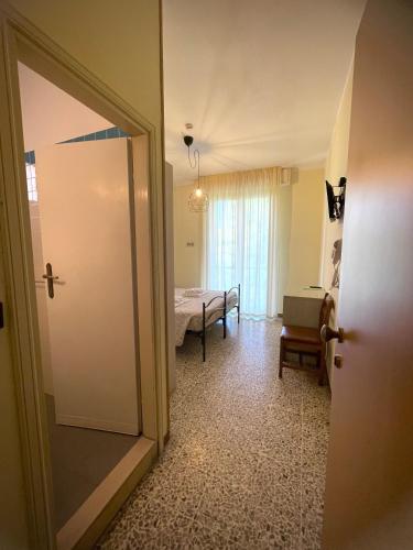 a room with a door leading to a bedroom at Hotel Reale in Rimini