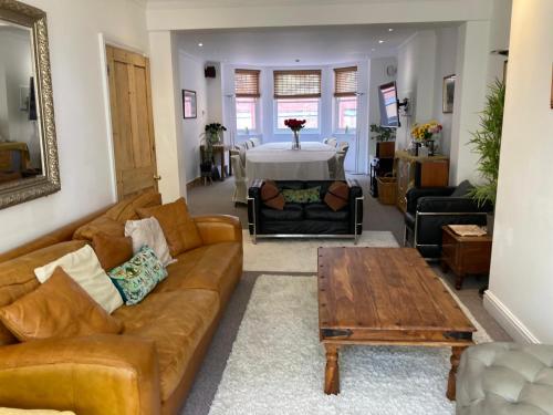 a living room with a couch and a table at The Palace Villas - Location, Luxury and Space in Eastbourne