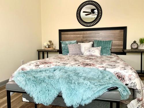a bedroom with a bed with a blue blanket on it at Huge 6BR Home , Modern & Convenient in Niagara Falls
