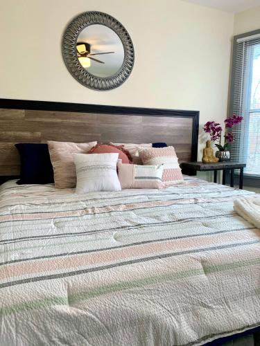 a bedroom with a large bed with a mirror on the wall at Huge 6BR Home , Modern & Convenient in Niagara Falls