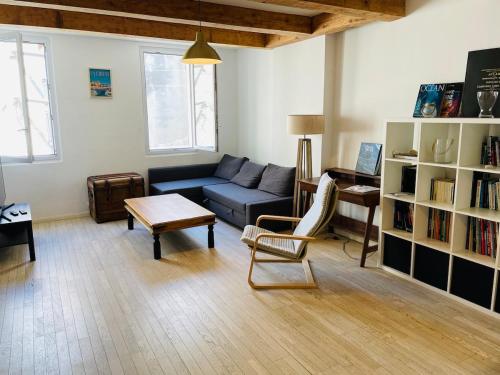 Una sala de estar con un sofá azul y una mesa. en Duplex La Ciotat - T2 - Plages & Vieux Port - climatisation, en La Ciotat