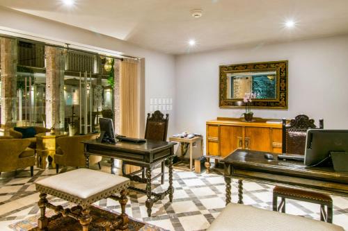 a living room with a piano and a table at Casa 1810 Hotel Boutique in San Miguel de Allende