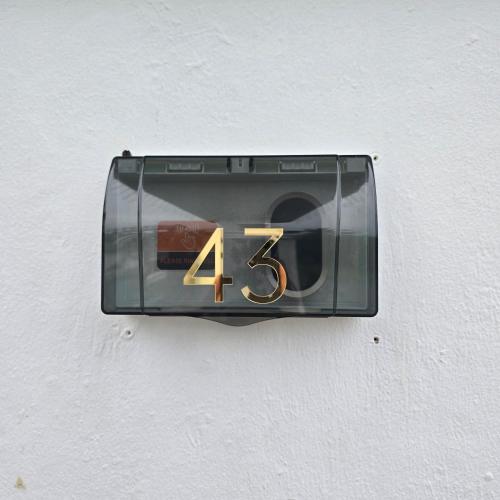a clock on the side of a wall with the number four at Magnificent White House Semporna in Semporna