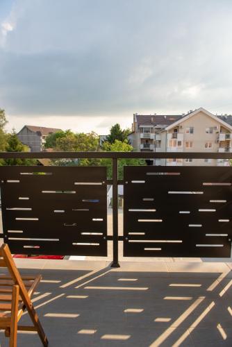 a view of a balcony with a bench and buildings at L & S Apartmani in Sombor