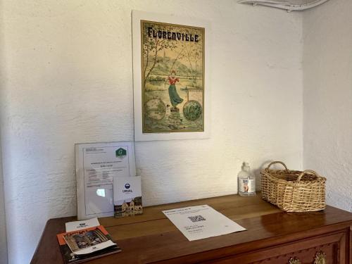 a desk with a picture of a chicken on a wall at Le Bocard in Abbaye dʼOrval