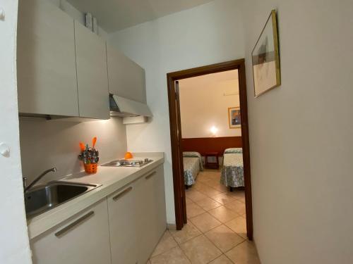 a kitchen with a sink and a counter top at Eden Appartamenti in Marina di Grosseto