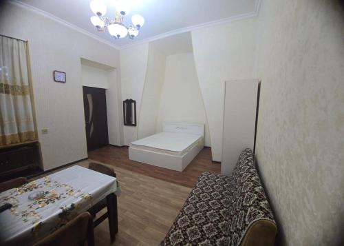 a room with a couch and a bed in it at Centerhome in Baku