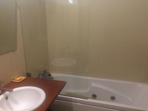 a bathroom with a sink and a bath tub with a shower at Luxury apartment in Espinho