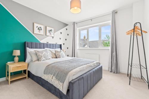 a bedroom with a bed and a window at 247 Serviced Accommodation in Telford 4BR House in Telford