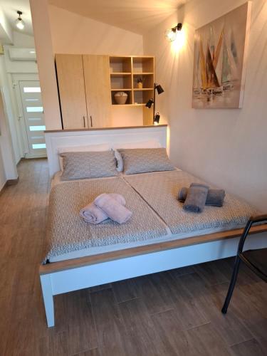 a bed with towels on it in a room at Apartmani Goga - Molat 6 in Molat