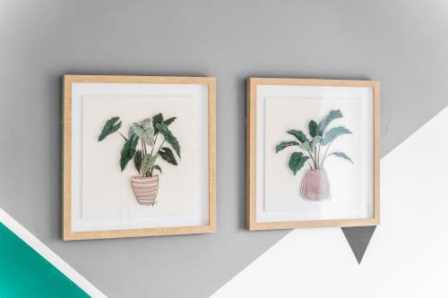 two framed drawings of plants on a wall at 247 Serviced Accommodation in Telford 4BR House in Telford