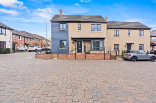 a house with a car parked in a driveway at 247 Serviced Accommodation in Telford 4BR House in Telford