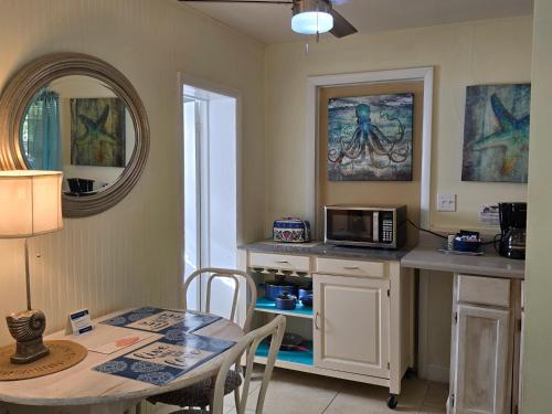 a small kitchen with a table and a microwave at Oceanfront Sea Scape Motel in Melbourne