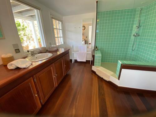 a bathroom with a shower and a sink and a tub at New ! Villa Vagabond in Quartier de Lorient