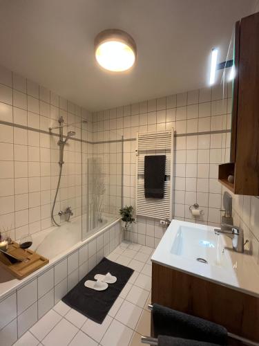 a bathroom with a tub and a sink at Ferienwohnung Glück Auf in Annaberg-Buchholz