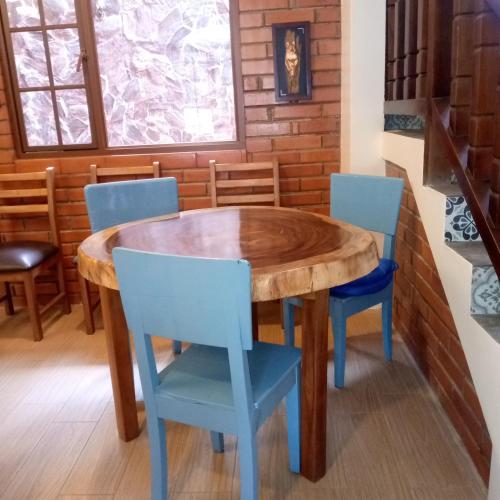 a wooden table and chairs in a room at The Lookout Hideaway in Baños