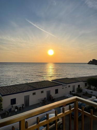 a view of the ocean at sunset from a balcony at Panoramico Appartamento Lido Conchiglie in Gallipoli
