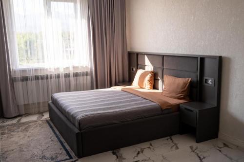 a bedroom with a large bed in a room at Urban Hotel in Almaty