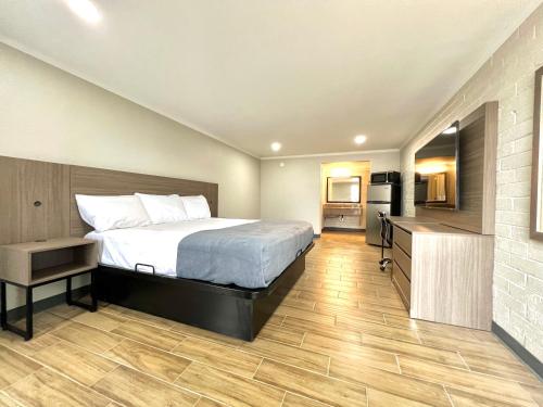 a hotel room with a bed and a kitchen at Economy Suites Extended Stay in Tulsa