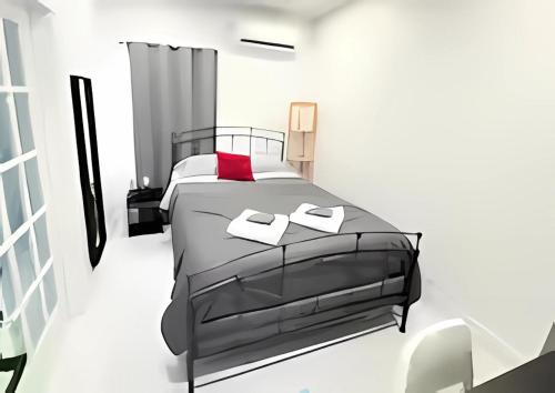 a bedroom with a black bed with a red pillow at Gorgeous Private Room, near the Airport - Free parking - 01 in Miami