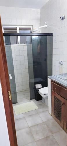 a bathroom with a shower and a toilet in it at Casa Cabugi Praia JR in Natal