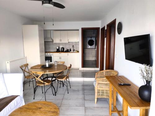 a kitchen and living room with a table and chairs at apartment by the sea in Neos Marmaras