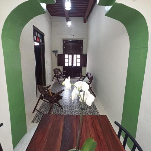 a dining room with a wooden table and chairs at Casa Al Mar in Campeche