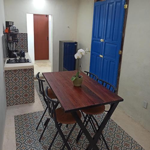 a wooden table with a flower on it in a kitchen at Casa Al Mar in Campeche