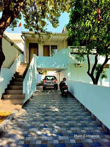a car parked in front of a house at Ved Homestay in Dehradun