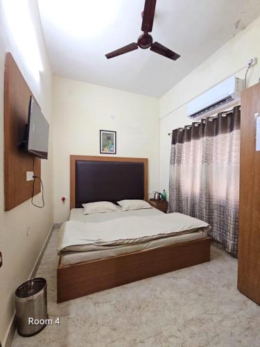 a bedroom with a bed and a ceiling fan at Ved Homestay in Dehradun