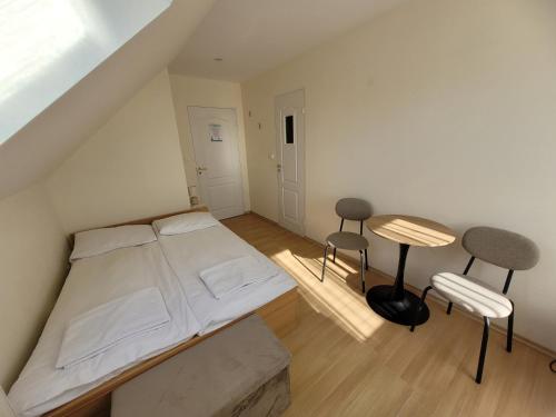 a bedroom with a bed and a table and chairs at Boja Rewal in Rewal